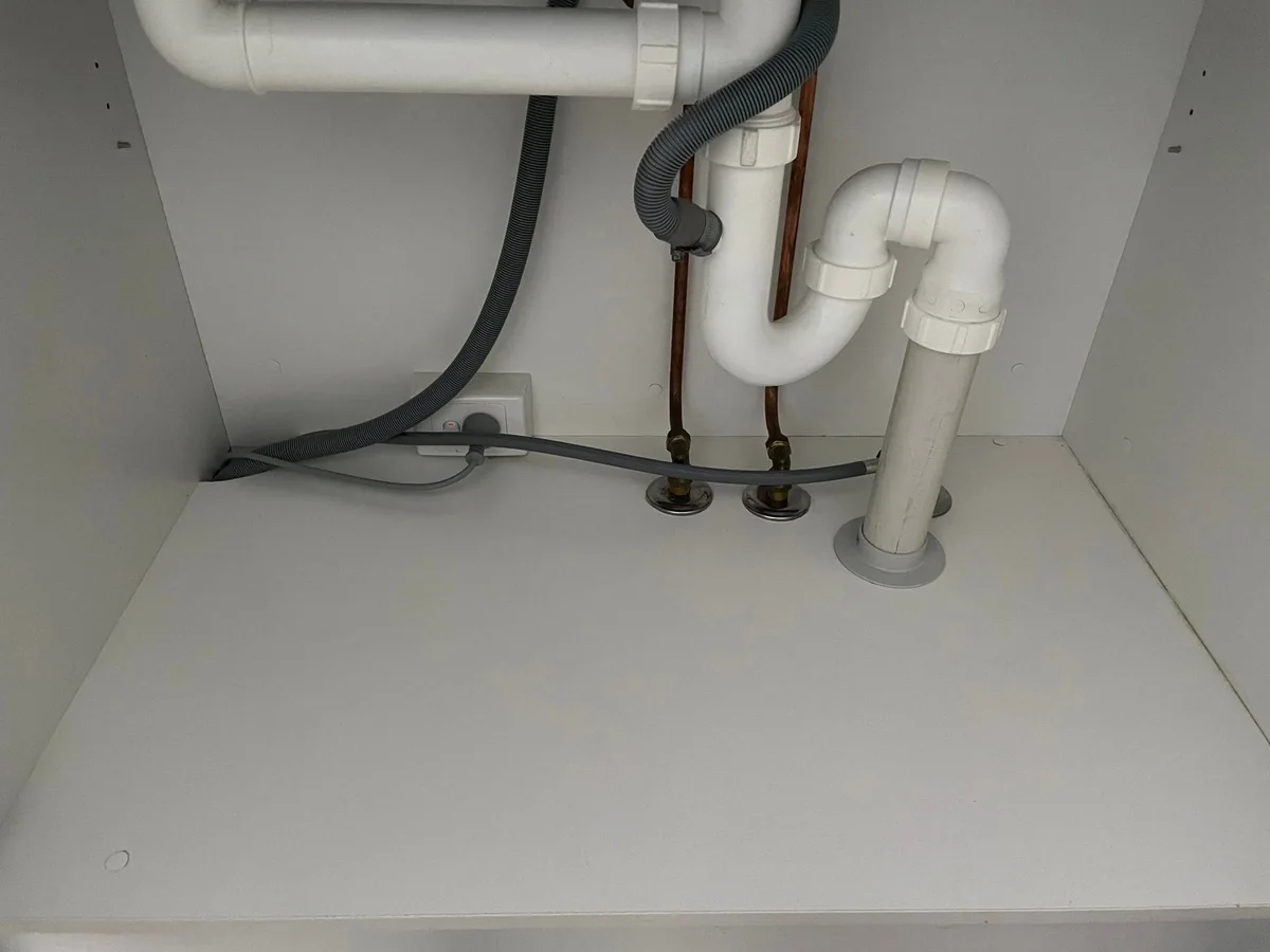 Cleaned under-sink cupboard interior after wiping and detailing
